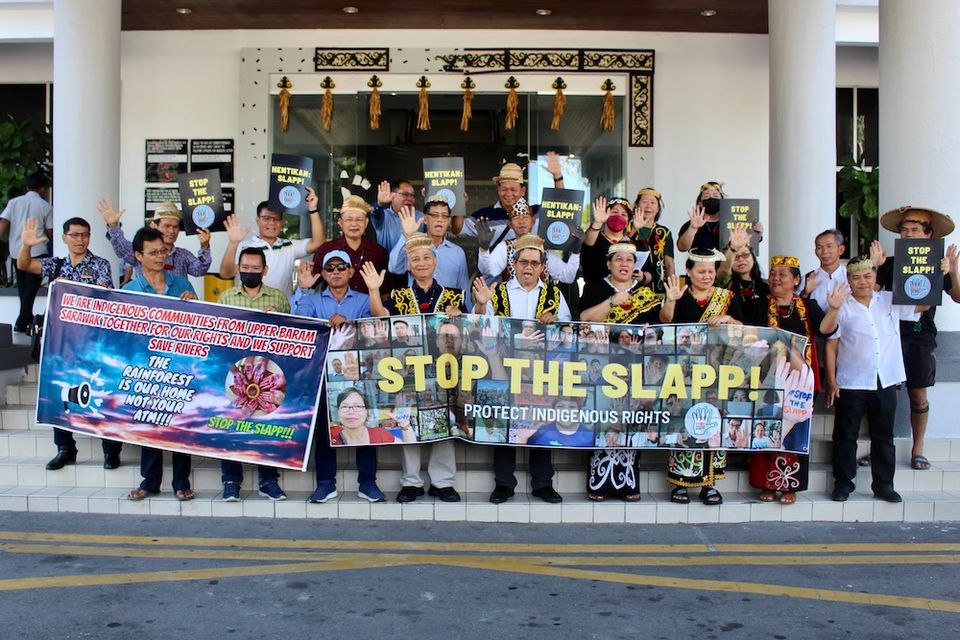 Activists demonstrate outside the Miri High Court in Malaysia.